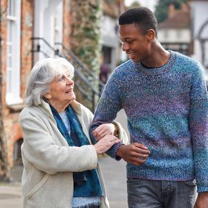 Young man escorting older woman